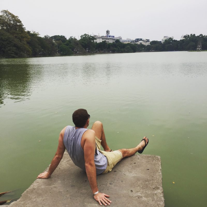 Man looking over lake in Vietnam