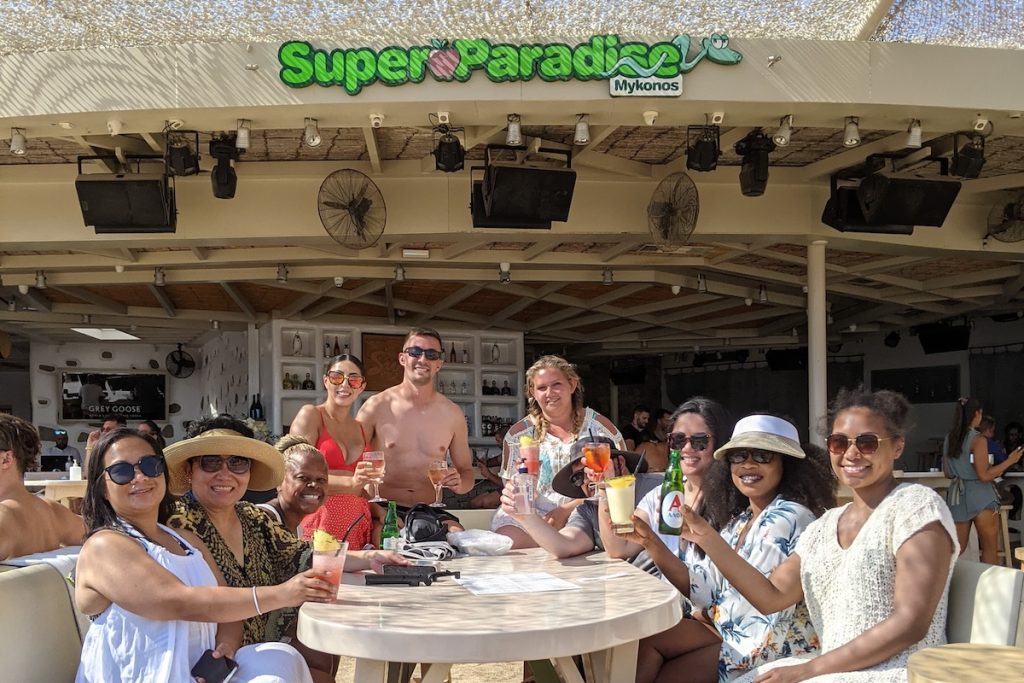 Group tour guests with their tour leader at Super Paradise Beach Club in Mykonos