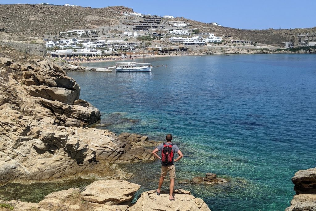 Tour leader overlooking Paradise Beach in Mykonos, Greece