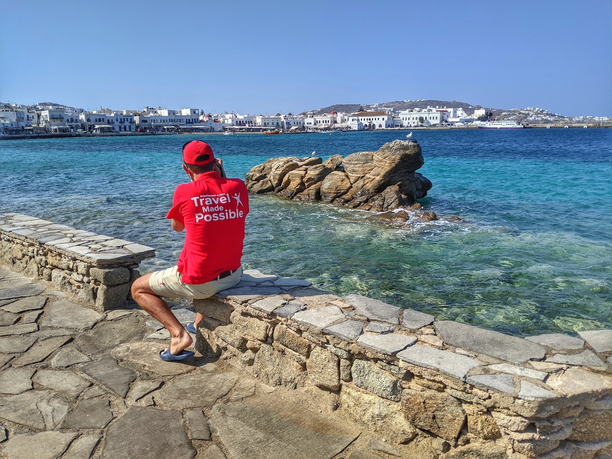 Tour leader photographing Mykonos Town for a complete Mykonos travel guide