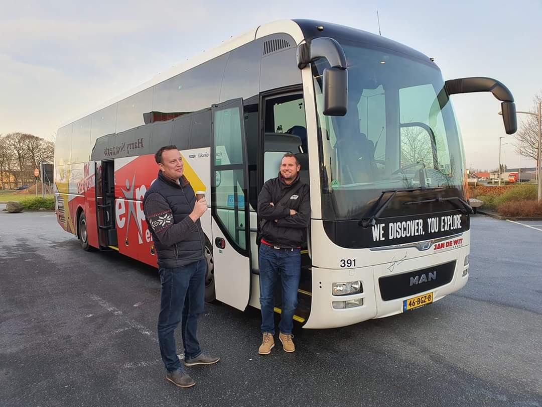 European tour leader with tour coach and driver