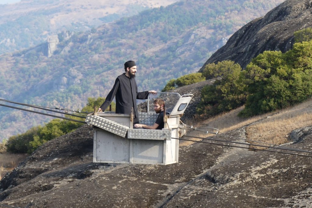 Meteora travel guide - Monk in cable car trolley