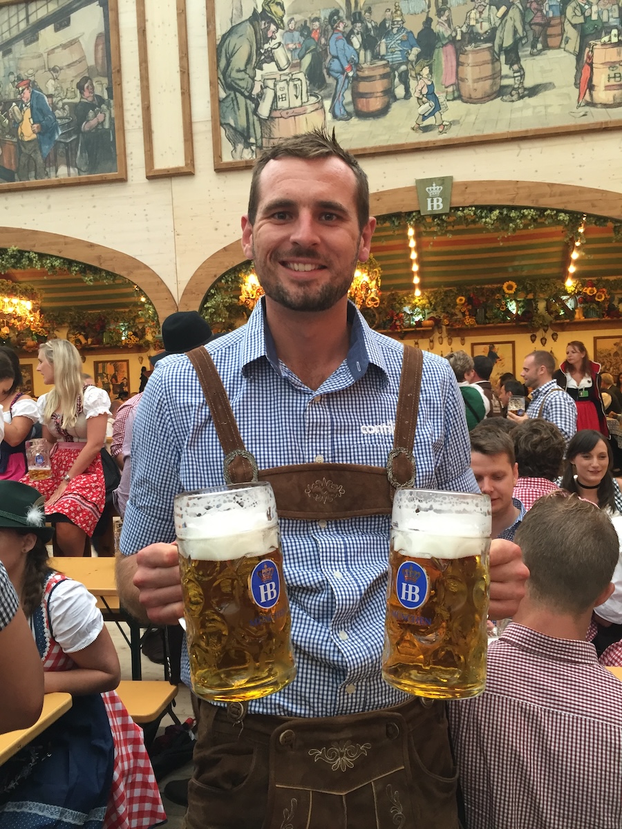 Tour Leader in beer tent holding beer steins