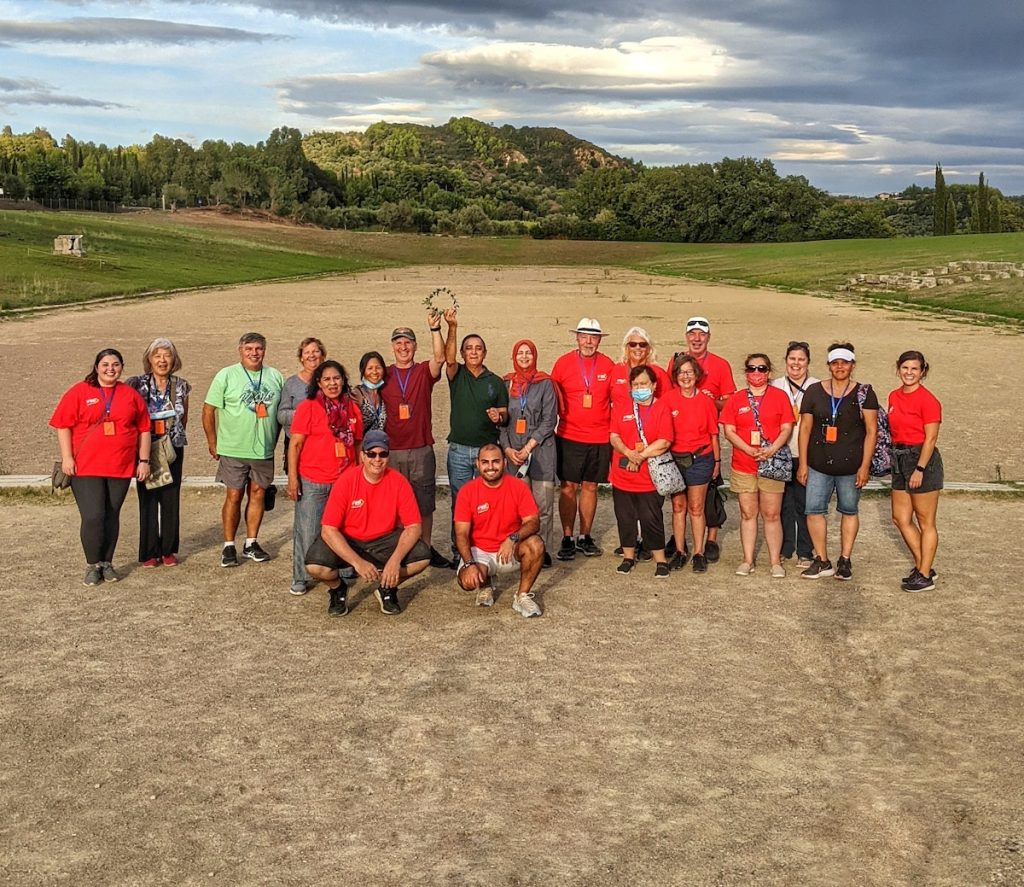 Expat Explore Best of Greece tour group standing on ancient Olympia running track