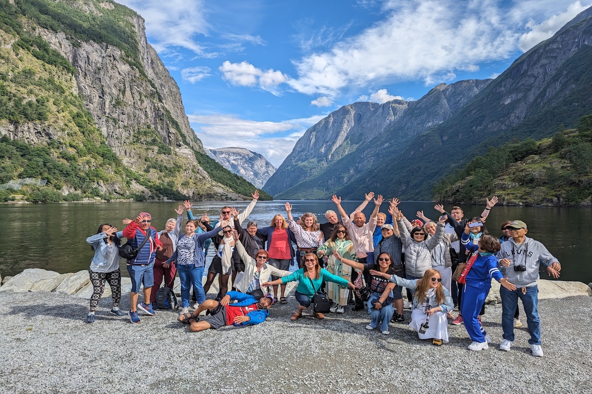 Expat Explore Best of Scandinavia & the Baltics group photo in front of Norwegian Fjord